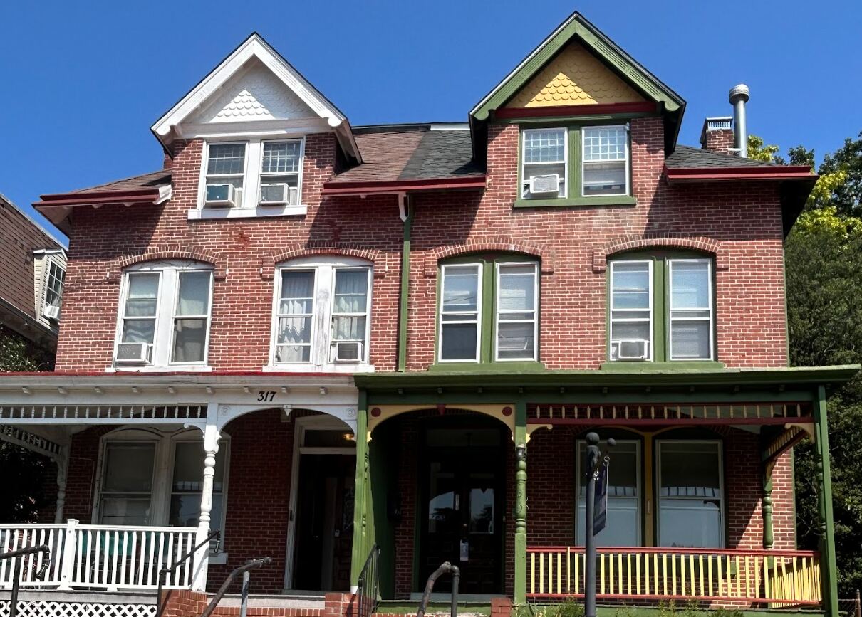 Red brick Victorian student house with front porch in West Chester PA